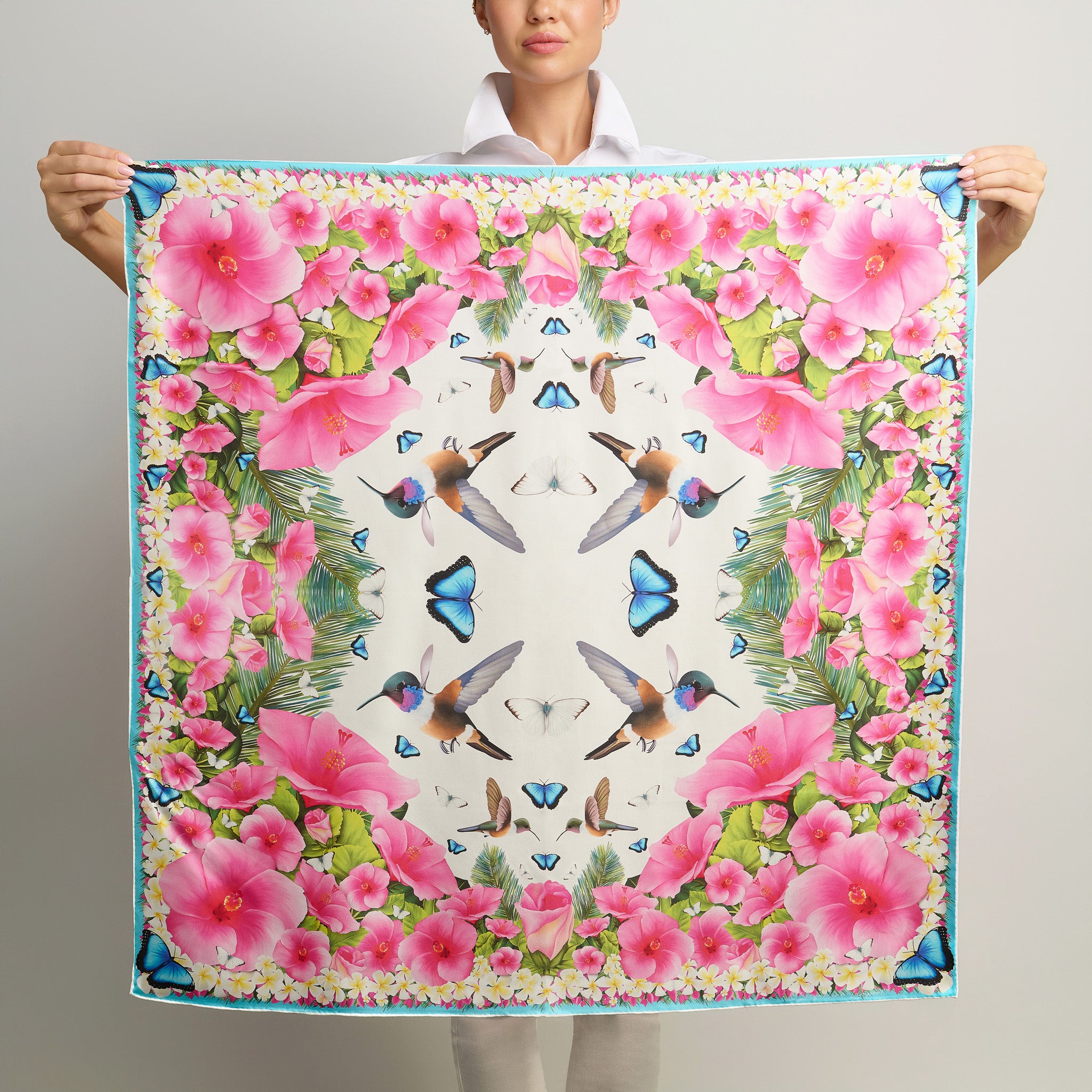 White luxury silk scarf featuring tropical hibiscus flowers hummingbirds blue morpho butterflies and frangipani blooms.