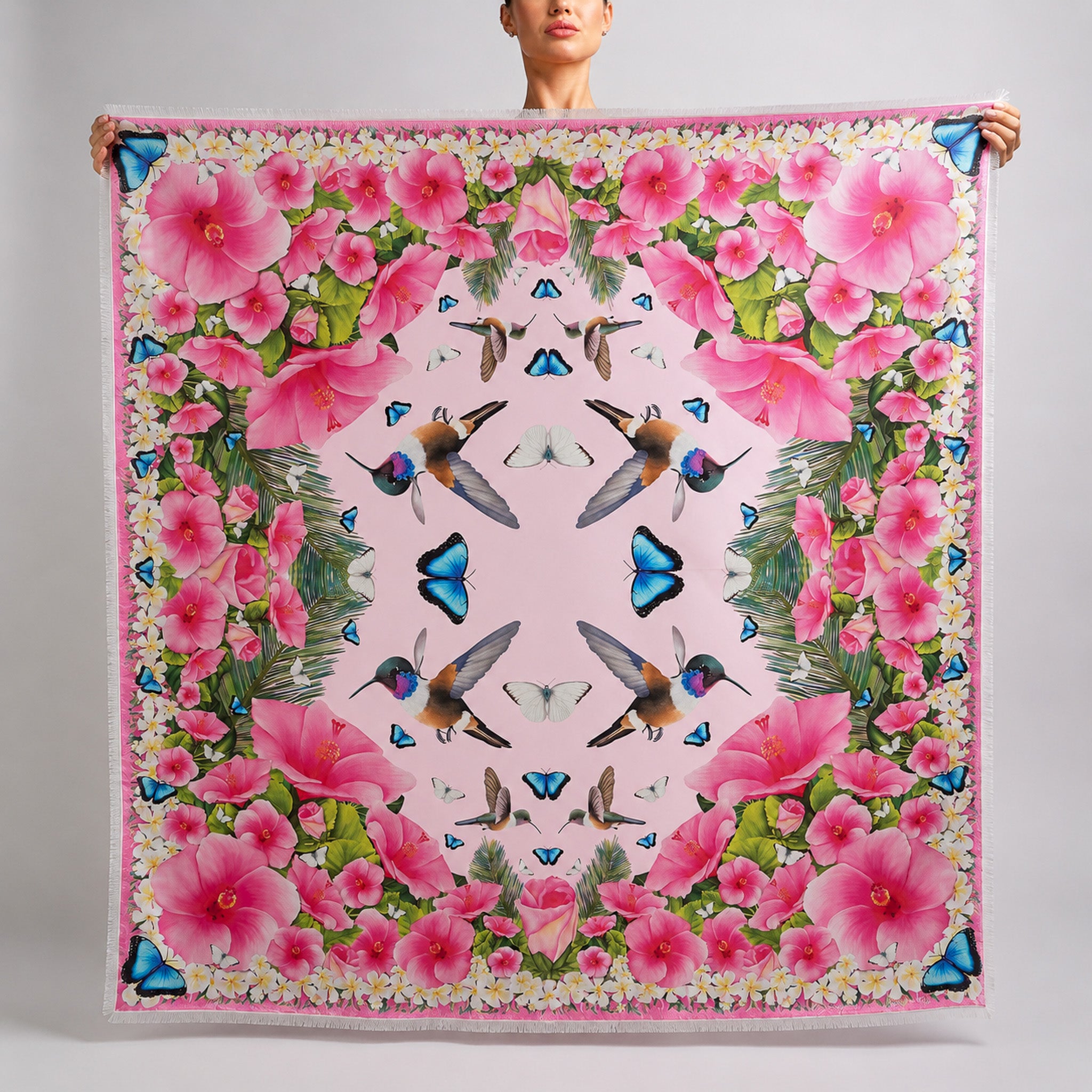 Pale pink grande silk scarf featuring hand-drawn Bahama Woodstar hummingbirds, hibiscus flowers, blue morpho butterflies, palm leaves, and frangipani inspired by the Caribbean
