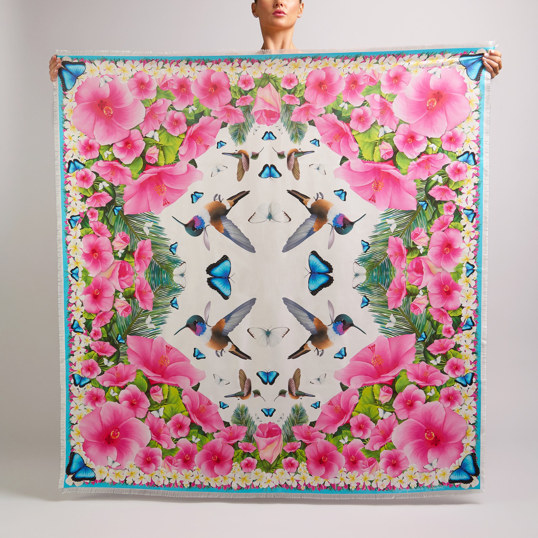 White grande silk scarf featuring hand-drawn Bahama Woodstar hummingbirds, hibiscus flowers, blue morpho butterflies, palm leaves, and frangipani inspired by the Caribbean